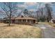 A well maintained brick home with mature trees, driveway and manicured yard at 224 E Felton Rd, Cartersville, GA 30121