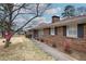 Side view of a brick home with black shutters and a manicured landscape at 224 E Felton Rd, Cartersville, GA 30121