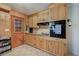 Efficient kitchen with wood cabinets, stone countertops, and modern appliances at 224 E Felton Rd, Cartersville, GA 30121