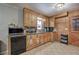 Bright kitchen featuring wooden cabinets, granite countertops, and tile flooring at 224 E Felton Rd, Cartersville, GA 30121