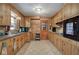 Well-lit kitchen with wood cabinets, granite countertops, and access to the back at 224 E Felton Rd, Cartersville, GA 30121
