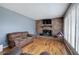 Open living room features hardwood floors, brick fireplace, and lots of natural light at 224 E Felton Rd, Cartersville, GA 30121