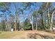 Large private backyard featuring a lawn area and mature trees, perfect for recreation at 2316 Miriam Ln, Decatur, GA 30032