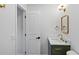 Fresh bathroom with a white door, modern vanity, marble countertop, and stylish brass hardware at 2316 Miriam Ln, Decatur, GA 30032