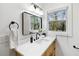 Bright bathroom features a modern vanity, sleek black fixtures, and a view to the outside at 2316 Miriam Ln, Decatur, GA 30032