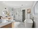 Bright bathroom featuring marble floors, a soaking tub, a glass enclosed shower and modern fixtures at 2316 Miriam Ln, Decatur, GA 30032