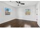 Clean bedroom with hardwood floors, neutral walls, a ceiling fan, and windows with nature views at 2316 Miriam Ln, Decatur, GA 30032