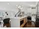 Open kitchen and living room with modern finishes, a large island, and hardwood floors at 2316 Miriam Ln, Decatur, GA 30032