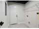 Laundry room with modern tile floor, shelving, and white door at 2316 Miriam Ln, Decatur, GA 30032