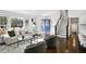 Bright living room with large windows, hardwood floors, and a blue front door at 2316 Miriam Ln, Decatur, GA 30032