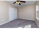 Bedroom with gray carpet, neutral paint, a ceiling fan, and closet for storage at 2775 Capri Dr, Cumming, GA 30041