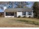 Charming single-story home featuring white siding, black shutters, a well-maintained lawn and inviting front door at 2775 Capri Dr, Cumming, GA 30041