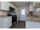 Galley kitchen includes stainless steel appliances, granite countertops, and white cabinets at 2775 Capri Dr, Cumming, GA 30041