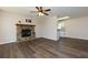 Spacious living room featuring a stone fireplace, ceiling fan, and stylish vinyl flooring at 2775 Capri Dr, Cumming, GA 30041