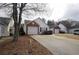An exterior shot of a single-story house with an attached garage and a paved driveway at 2800 Barnwood Xing, Duluth, GA 30097