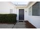 Exterior view of a dark gray front door with trimmed hedges along the sidewalk at 2800 Barnwood Xing, Duluth, GA 30097