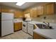 Bright kitchen with white appliances, tiled floors, and wood cabinets at 2800 Barnwood Xing, Duluth, GA 30097