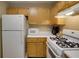 Standard kitchen with wooden cabinets, microwave, and gas range at 2800 Barnwood Xing, Duluth, GA 30097