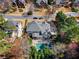 Stunning aerial view of a home featuring a backyard swimming pool, patio area, and lush landscaping at 65 Gatewood Dr, Marietta, GA 30068