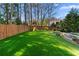 Spacious backyard featuring lush artificial turf, a playset, and privacy fencing for outdoor fun and relaxation at 65 Gatewood Dr, Marietta, GA 30068