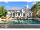 Backyard showcasing a stunning in-ground pool, spa, patio furniture, and manicured lawn, ideal for leisure at 65 Gatewood Dr, Marietta, GA 30068