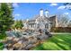 Stunning backyard featuring a pool, hot tub, stone patio and lush landscaping, perfect for outdoor entertaining at 65 Gatewood Dr, Marietta, GA 30068