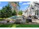 Backyard view of the pool, outdoor kitchen, lush landscaping, and pristine exterior of the home at 65 Gatewood Dr, Marietta, GA 30068