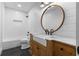 Modern bathroom featuring a vintage-style vanity, round mirror, and subway tile walls at 65 Gatewood Dr, Marietta, GA 30068