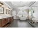 Bathroom featuring double vanities, soaking tub and a glass enclosed shower at 65 Gatewood Dr, Marietta, GA 30068