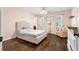 Cozy bedroom with tufted headboard, hardwood floors, and a comfortable armchair at 65 Gatewood Dr, Marietta, GA 30068