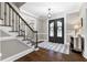 Spacious foyer featuring hardwood floors, and a staircase with wrought iron spindles at 65 Gatewood Dr, Marietta, GA 30068