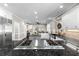 Gourmet kitchen featuring stainless steel appliances, granite countertops, and a center island cooktop at 65 Gatewood Dr, Marietta, GA 30068