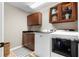Functional laundry room featuring modern appliances and ample cabinet storage at 65 Gatewood Dr, Marietta, GA 30068