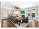 Elegant living room with fireplace, hardwood floors, and view of the outdoor swimming pool at 65 Gatewood Dr, Marietta, GA 30068