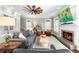Inviting living room features a fireplace, hardwood floors, built-in shelves, and a modern ceiling fan at 65 Gatewood Dr, Marietta, GA 30068