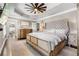 Elegant bedroom features a tufted headboard, tray ceiling with fan, and hardwood floors at 65 Gatewood Dr, Marietta, GA 30068