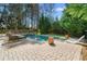 Backyard pool area featuring a patio with lounge chairs, lush greenery, and a relaxing outdoor space at 65 Gatewood Dr, Marietta, GA 30068