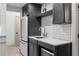 Chic wet bar features modern cabinets, stylish backsplash, and stainless-steel appliances at 65 Gatewood Dr, Marietta, GA 30068