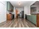 Well-lit kitchen boasting modern green cabinets, wood countertops, stainless steel appliances, and stylish backsplash at 1201 Red Bud Ln, Canton, GA 30114