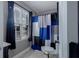 A well-lit bathroom features a colorful shower curtain and a window with natural light at 2077 Towne Mill Ave, Canton, GA 30114