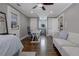 Bright, comfortable bedroom with a seating area, white trim, hardwood floors, and a ceiling fan at 2077 Towne Mill Ave, Canton, GA 30114