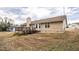 Back exterior of home with a deck and spacious backyard at 220 Timber Ln, Stockbridge, GA 30281