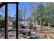 Backyard overlooking the lake with rock water feature and mature trees at 2382 Merrymount Dr, Suwanee, GA 30024