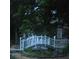 Charming backyard bridge featuring white railings and night lights at 2382 Merrymount Dr, Suwanee, GA 30024
