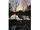 Backyard view with lake reflections and a sunset sky at 2382 Merrymount Dr, Suwanee, GA 30024