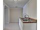 Basement wet bar area includes a stainless steel sink, granite countertop, and white cabinetry at 2382 Merrymount Dr, Suwanee, GA 30024