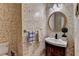 Cozy half bathroom with unique wallpaper and a decorative round mirror and faucet at 2382 Merrymount Dr, Suwanee, GA 30024