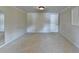 Spacious bedroom with neutral carpet, white door and trim, and ample wall space at 2382 Merrymount Dr, Suwanee, GA 30024