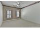 Bedroom with neutral walls, light carpeting, and large windows that provide abundant natural light at 2382 Merrymount Dr, Suwanee, GA 30024