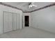 Bedroom features light carpeting, spacious closets, and a nearby doorway to the home's staircase at 2382 Merrymount Dr, Suwanee, GA 30024